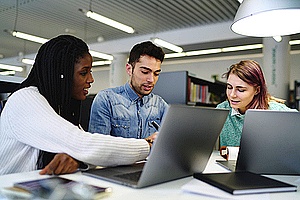 three developers discussing their software during the testing process