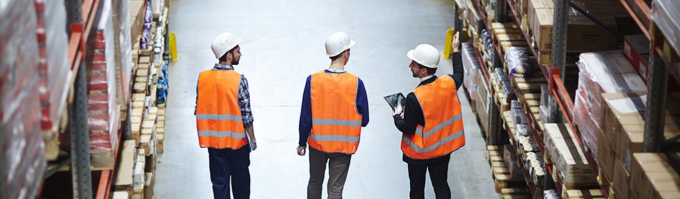 warehouse managers walking through the warehouse floors showing inventory