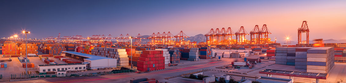 ship yard loading cargo onto ships in the morning