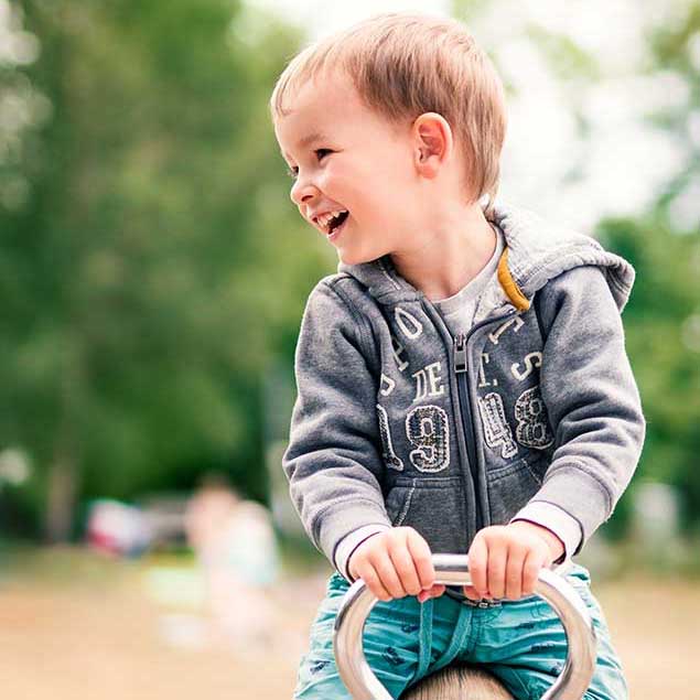 Child playing on Community Playthings toy