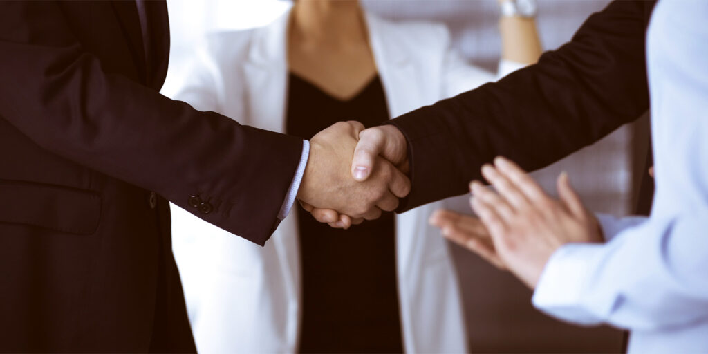 saas team member shaking hands with a business owner after saas staff augmentation