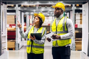 two engineers using manufacturing order software to record inventory