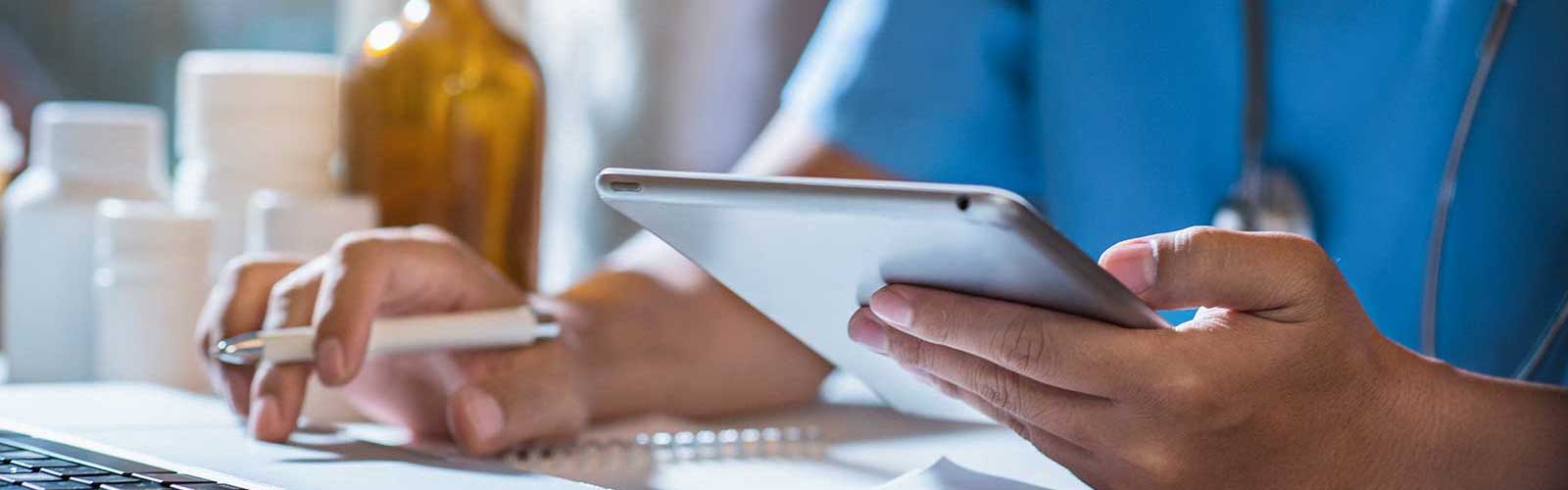Doctor on tablet receiving medical IT consulting from an expert