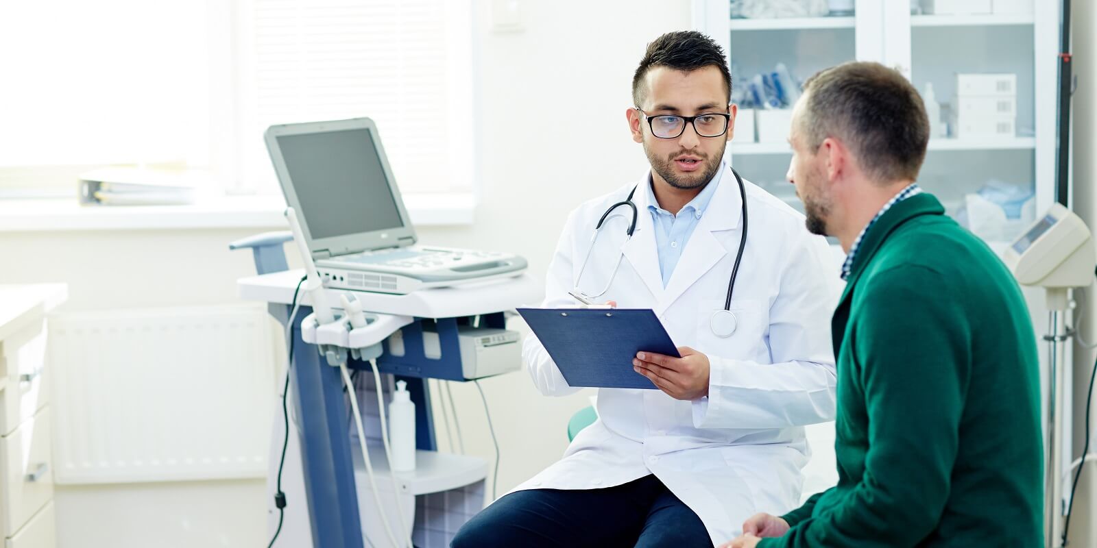 aged bearded patient having consultation with highly professional physician at modern office