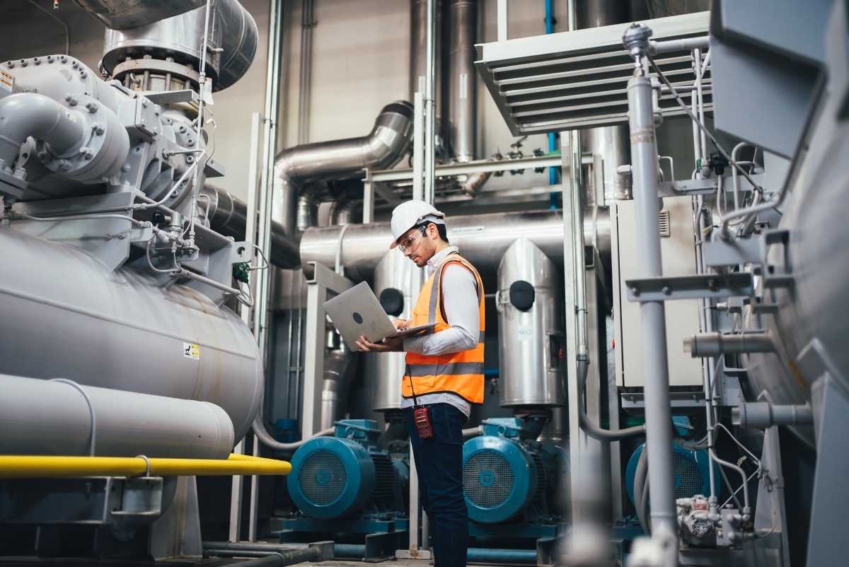 manufacturing professional looking over production using condition monitoring software