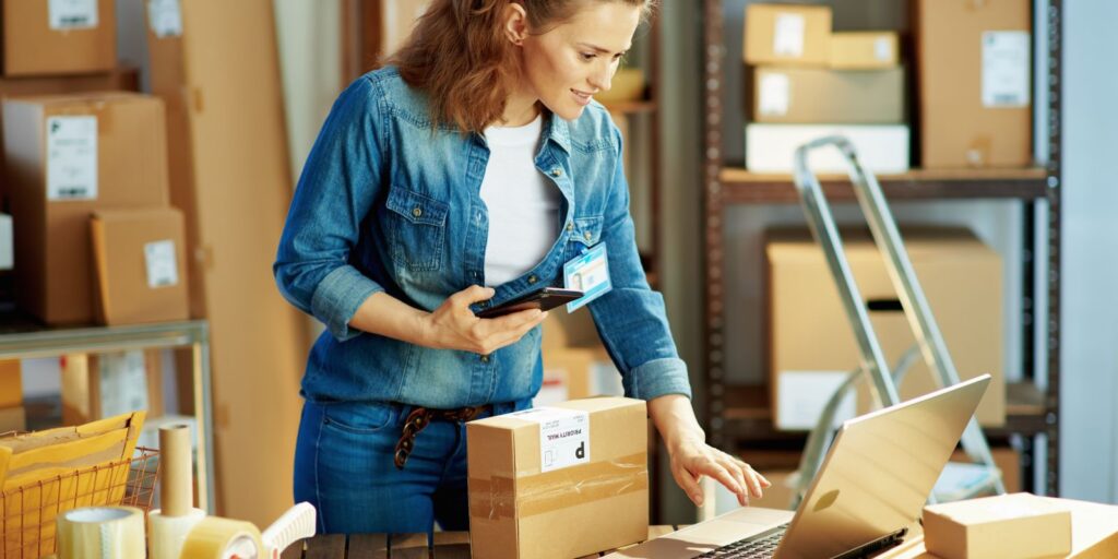 woman using a laptop to look at ecommerce orders