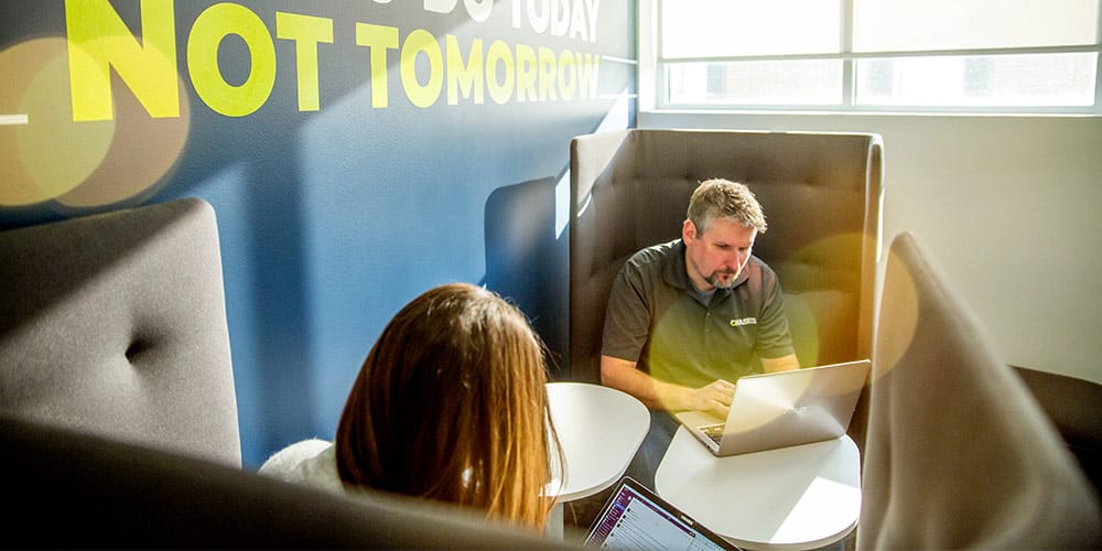 Orases team members on laptops