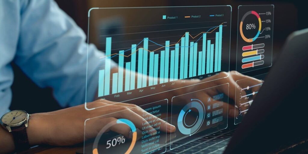 analyst works on personal computer showing business analytics dashboard with charts