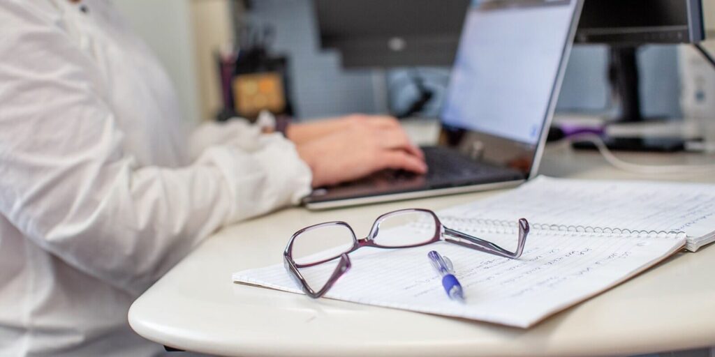 closeup shot of women specs and notepad