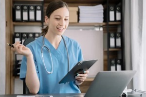 doctor working with software for medical billing on a tablet and smartphone search for medical information at the hospital office during the day