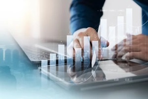 finance with a professional businessman use using laptop and tablet analyzing financial risk management software