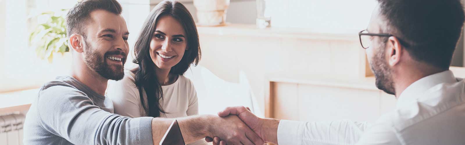 Insurance agent finalizing deal with clients