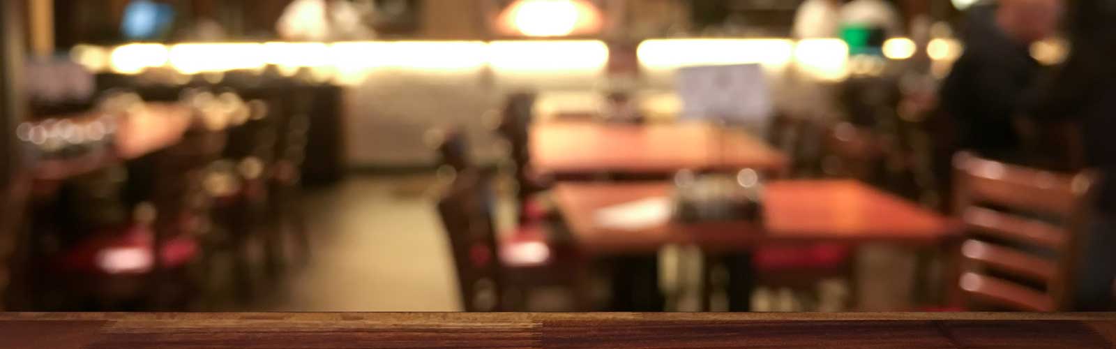 View of restaurant tables from behind a bar