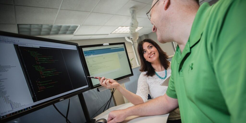 developers smiling during the discussion over a coding project