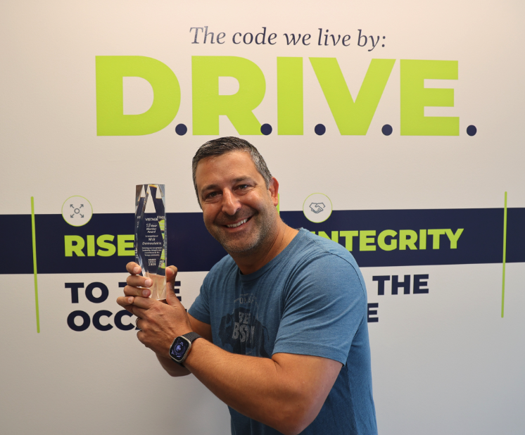 Orases CEO Nick Damoulakis holding the Vistage award.