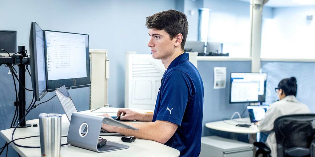 orases team member working on desktop computer