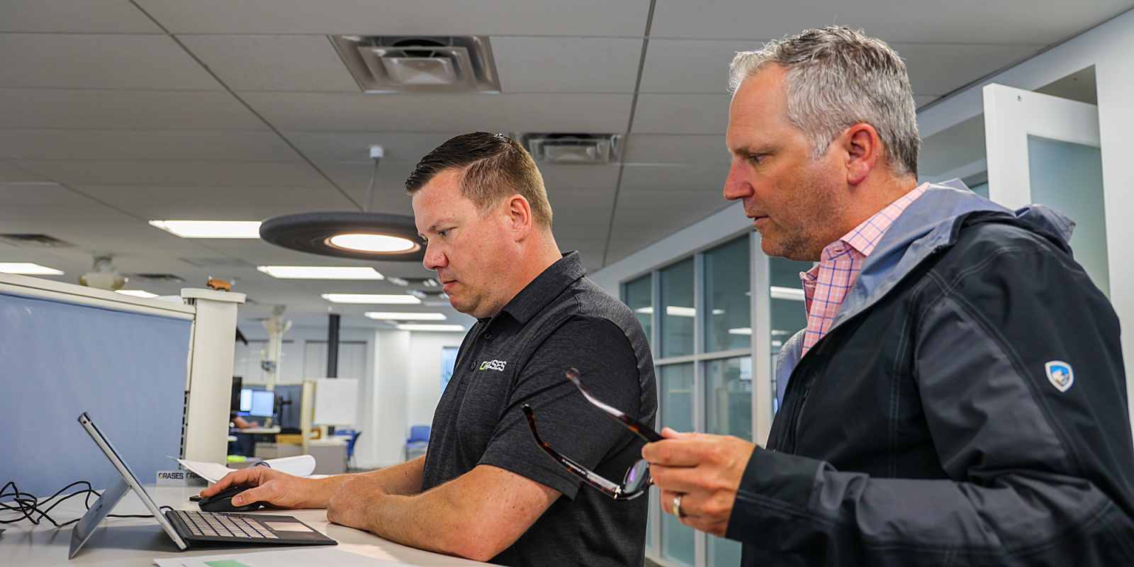 two data professionals reviewing data systems