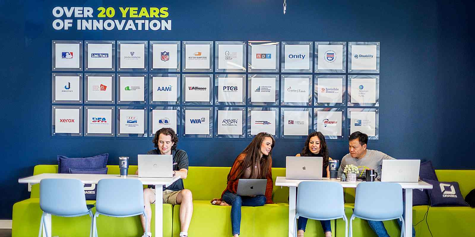 young professionals sitting and working on laptops