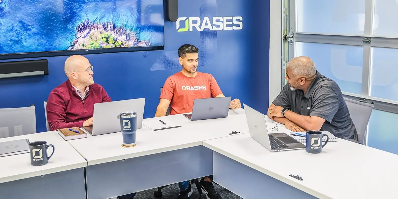 three teammates during a short break after an AI-Powered Document Approval Workflow meeting