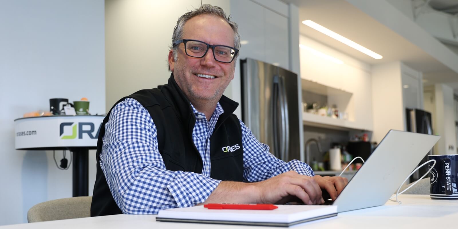 senior orases employee smiling at camera